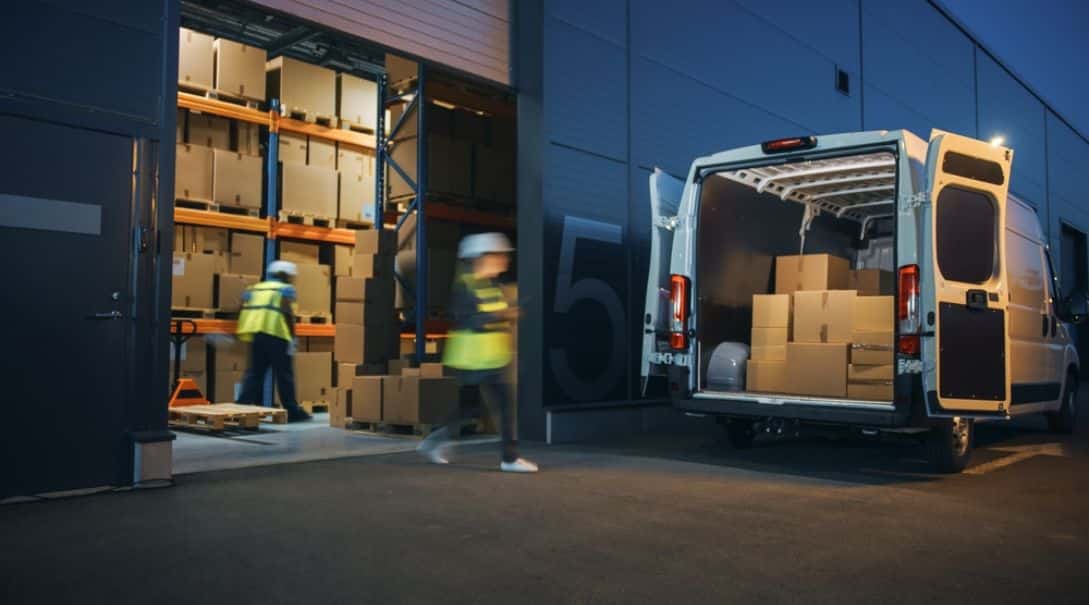 expedited shipping warehouse workers loading a delivery van
