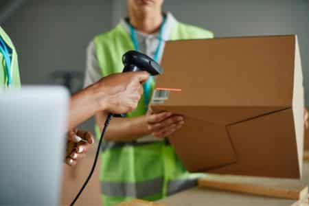 warehouse worker scanning barcode on package