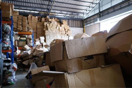 Boxes piled haphazardly in a warehouse