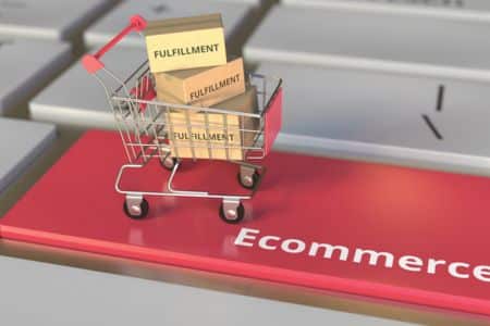 Mini shopping cart with fulfillment boxes on computer keyword.