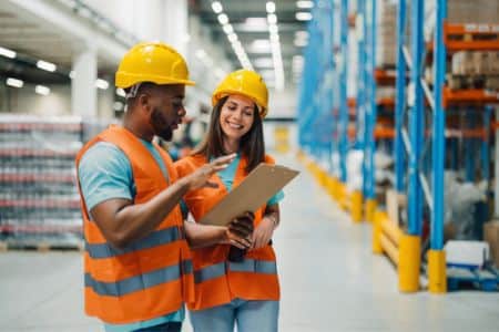warehouse staff reviewing inventory checklist