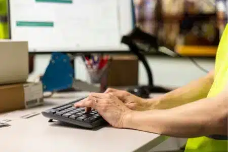warehouse employee entering order details and shipment information