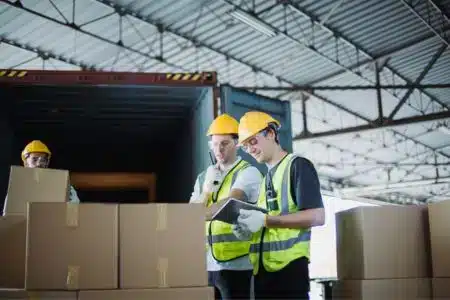 warehouse staff coordinating shipments and loading customer orders.